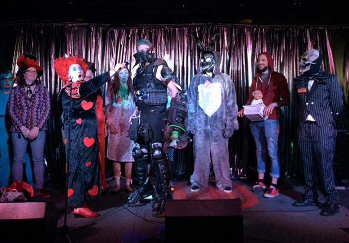 First-place winner Apocalypse Owl speaks with emcee DJ Callisto, while flanked by second-place winner Frank from Donnie Darko and third-place winner Regan from The Exorcist.